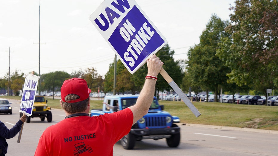 Striking United Auto Workers (UAW) union workers picket