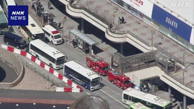 Passengers calmly evacuate the train station